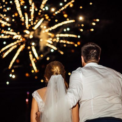 fireworks in the sky and the bride and groom